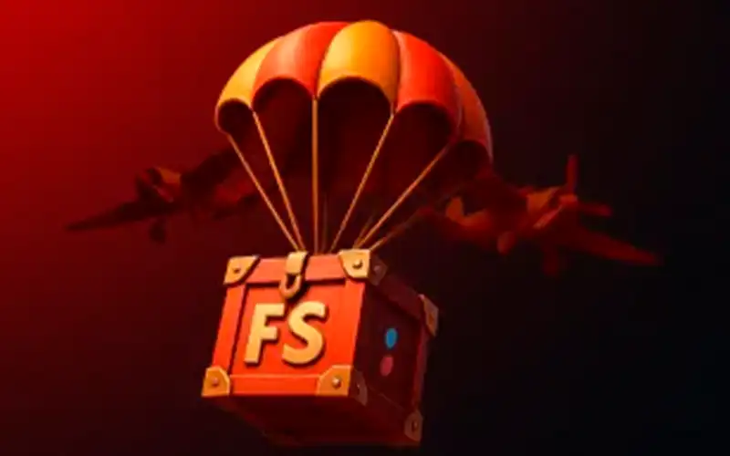 Cofre rojo marcado con FS colgado de un paracaídas, con aviones al fondo